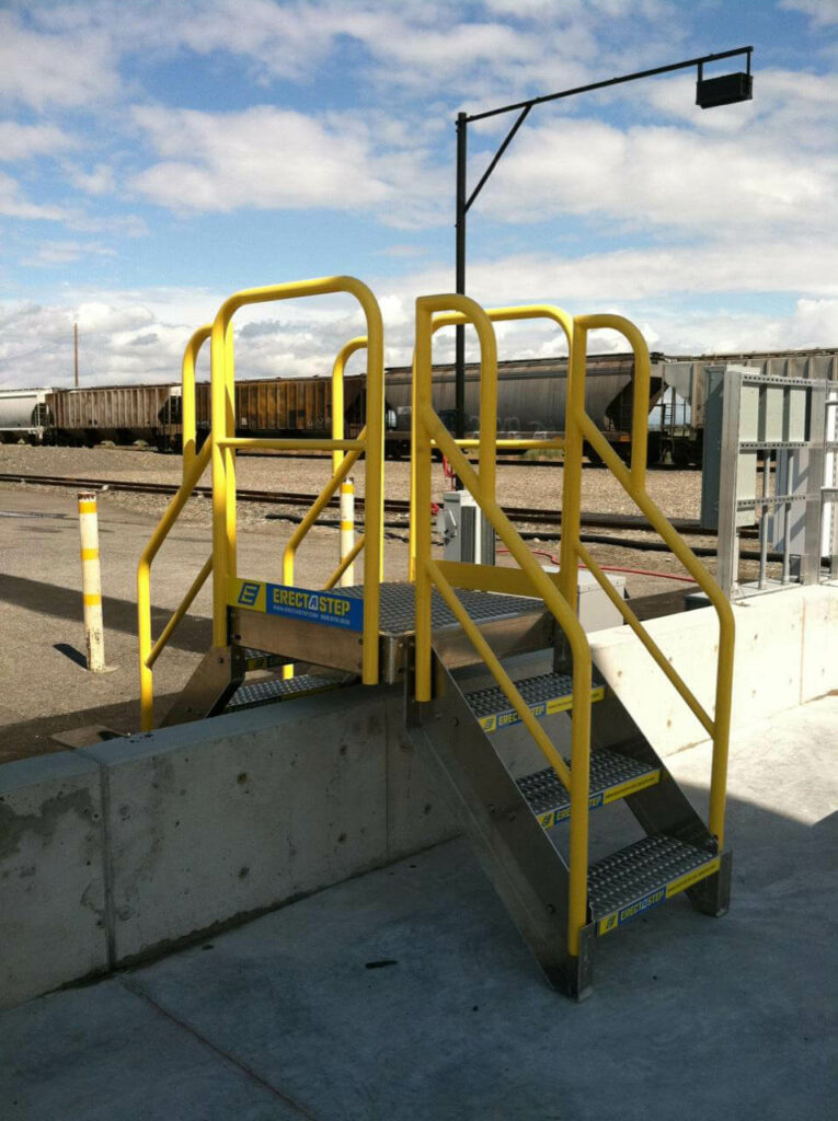 Erectastep industrial crossover stairs over cement wall