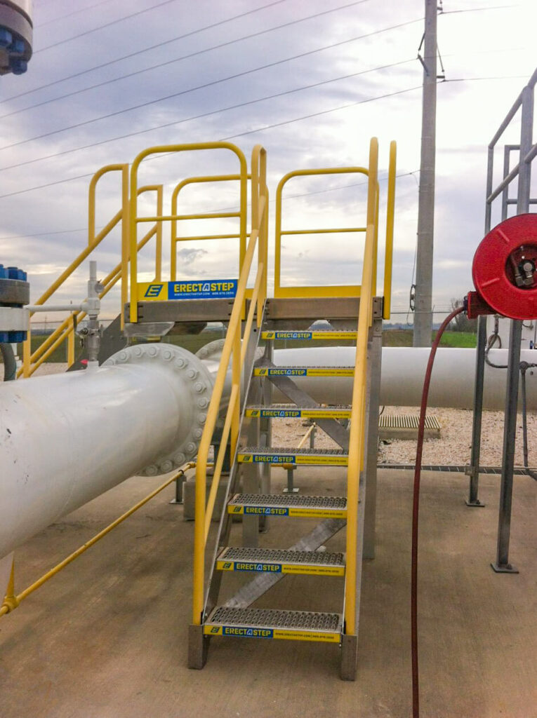 Erectastep multidirectional industrial crossover stairs across large pipe