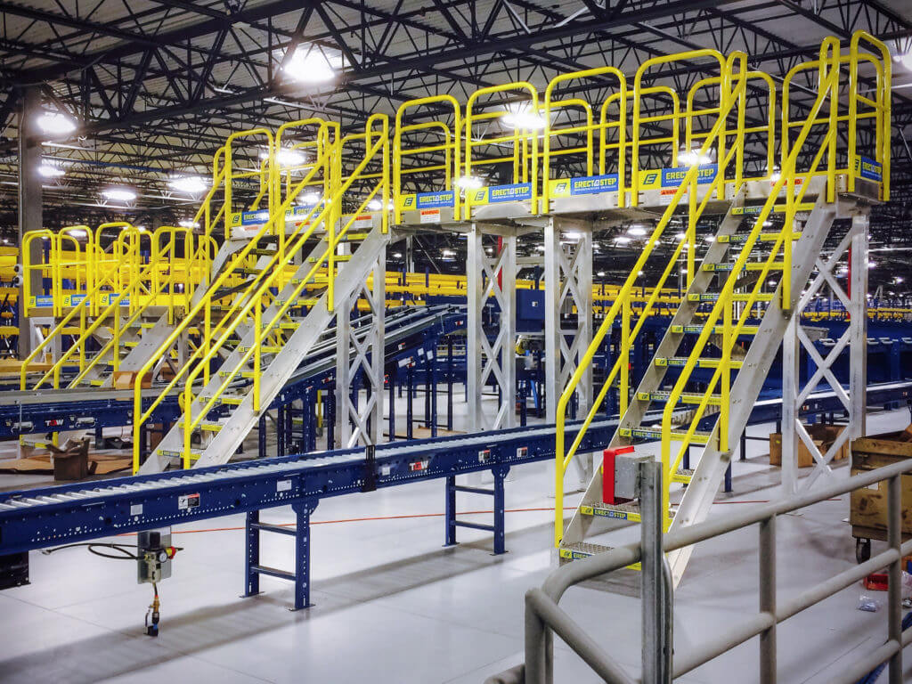 Crossover stairs unit over a production line in a manufacturing plant